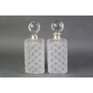Cut crystal decanters with silver collars elaborately cut…
