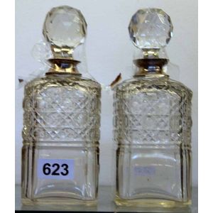 A pair of Victorian crystal glass decanters, with silver collar.…