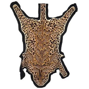 A Kashmiri embroidered long stitch leopard pelt, on black felt,…