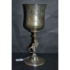 An elegant silver plated goblet with stem of a putti supporting…