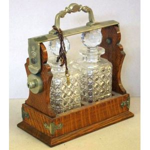 Victorian English two bottle tantalus, oak cased with keys, 29…