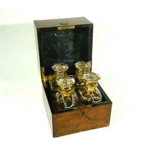 A Victorian walnut tantalus with key & four matching gilt Fleur…
