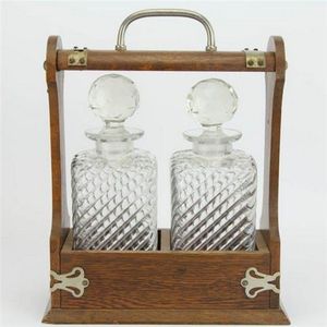 Victorian oak two bottle tantalus with a silver plated handle &…