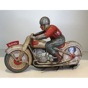 A tin motorcycle racer wind-up toy (no. 2) by Technofix, made…