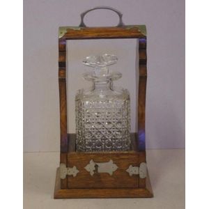 Victorian single decanter tantalus, in oak case with metal…