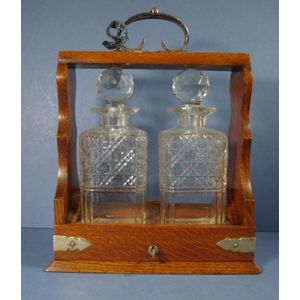 Antique English two bottle tantalus, oak cased with keys, 33 cm…