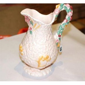 A Clarice Cliff milk jug, harvest pattern, 19 cm high