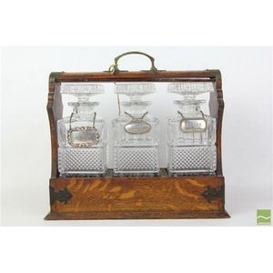 Silky oak tantalus containing crystal decanters with hallmarked…