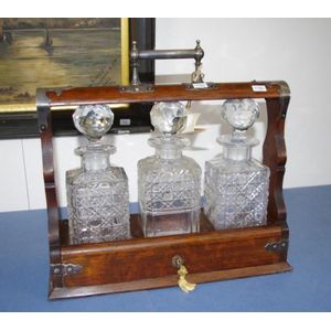 Victorian oak three bottle tantalus, Walker and Hall silver…