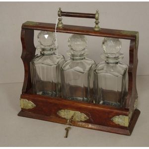 Vintage oak cased three decanter tantalus, with silver plated…