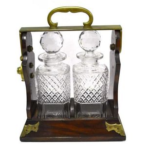 A Betjemann oak & brass tantalus with two crystal decanters,…