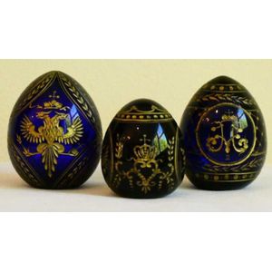 Three Faberge modern blue glass and gilded eggs bearing Romanov…