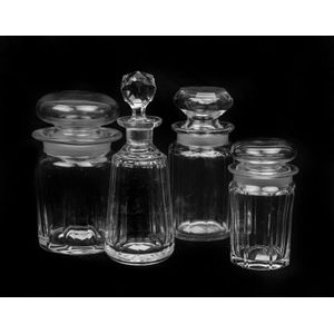 A collection of faceted crystal scent flasks and apothecary…