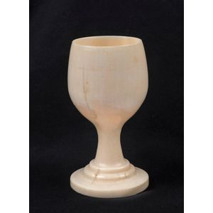 An antique eggcup made from turned whale's tooth, 19th century…