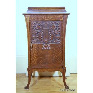 An oak music cabinet, early 20th century, having a galleried…
