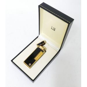 A black enamel and gold metal Dunhill lighter, in fitted box