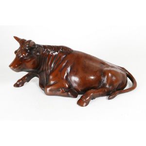 A cast iron model of a recumbent bull, with bronze patination.…