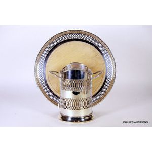 A silver plated wine bottle holder and a bread tray, early to…