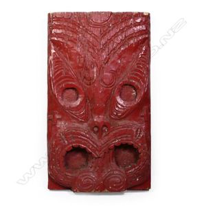 A large Maori stylised carved mask, unusually with crosses to…