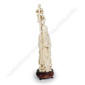 A Chinese carved ivory figure of Shou Lao, standing holding the&hellip;