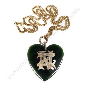 A 9ct yellow gold chain with colonial pounamu and 9ct heart…