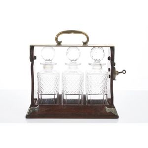 Victorian oak and brass tantalus c. 1860 with three cut crystal…