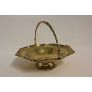 A Victorian silver gilt swing handle basket. By Martin and Hall,…