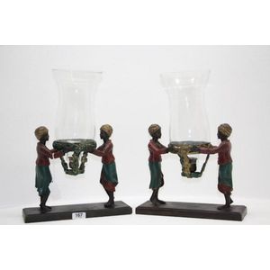 A pair of spelter Nubian candle lamps. Having two Nubian…