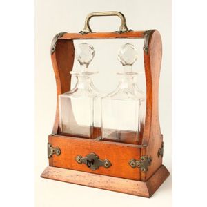 Oak and brass two decanter tantalus, brass carry handle and…