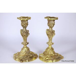 A pair of French cast ormolu candlesticks, late 19th century,…