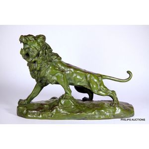 A bronze lion by Thomas Cartier (1879-1943), in a green…