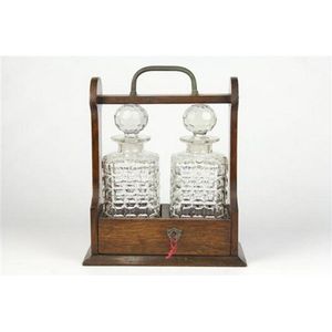 Victorian oak two bottle tantalus with a brass handle & mounts,…
