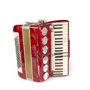 A mottled red plastic Tientan piano Accordion, some key covers…