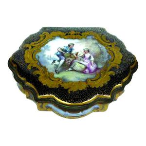 An old Sevres porcelain casket, of serpentine form, the hinged…