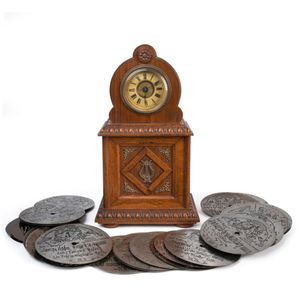 A German musical clock with 4½' disc player accompanied by…