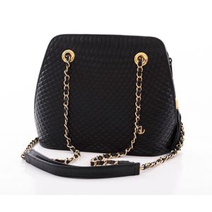 A vintage handbag by Guy Laroche, styled in black quilted…