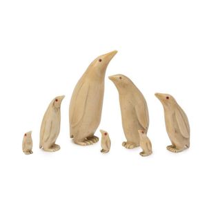 A set of 7 graduated penguin figures, carved whale's tooth, the…