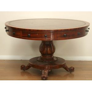 A Victorian mahogany drum table with inset leather top, with…