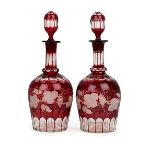A pair of antique English ruby overlay glass decanters with…