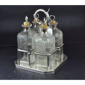 A Georgian sterling silver 4 bottle tantalus 1812 London, the…