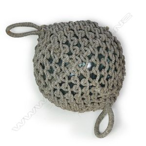 A large old glass fishing float with netting, hand blown.