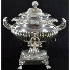 A large ornate silver plated samovar having a classical squat…