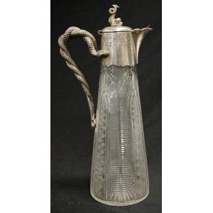 Antique silver plated and cut glass claret jug with figural…