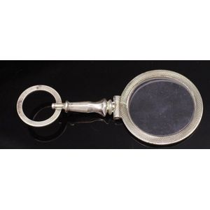 Antique silver quizzing glass with engine turned decoration.…
