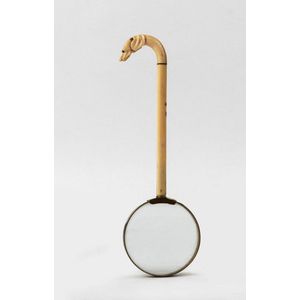 A brass and ivory magnifying glass,19th century, the curved…