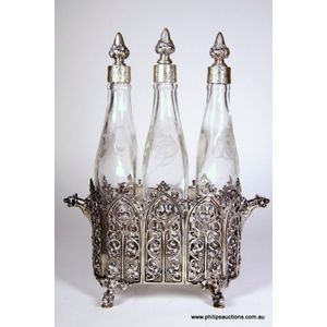 A German. 800 silver and glass three bottle silver cruet, late…