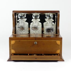 An Edwardian Sheraton revival mahogany games tantalus, three…