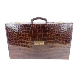 An impressive crocodile skin fitted travelling case, with…