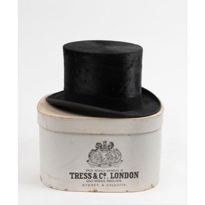 An antique top hat in original card box branded 'Tress & Co.',