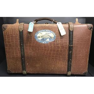 A c.1920s faux crocodile skin suitcase bearing Pan American…